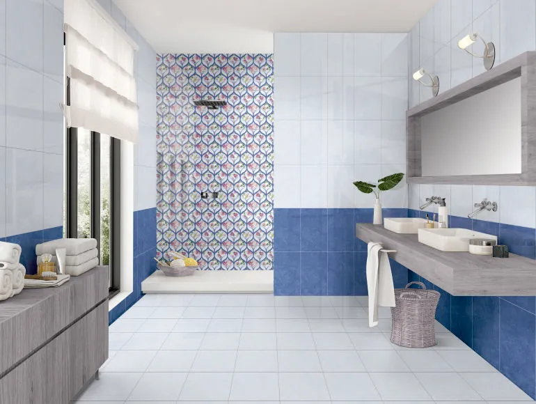 Stylish blue bathroom design featuring ocean blue tiles, a sink and a large window